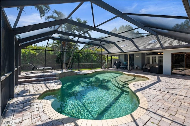 pool with a lanai and a patio area