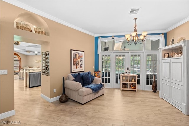 sitting room with crown molding, light wood-style flooring, visible vents, baseboards, and a notable chandelier