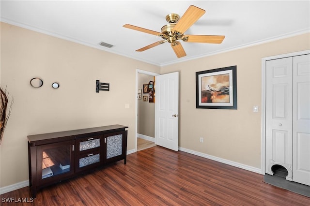 bedroom featuring baseboards, ornamental molding, a ceiling fan, visible vents, and dark wood finished floors