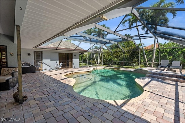 outdoor pool with a patio and a lanai