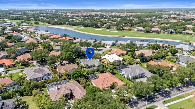 bird's eye view with a water view, golf course view, and a residential view