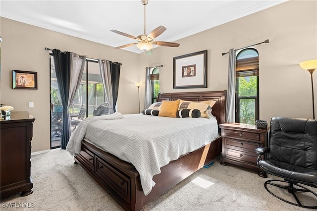 bedroom featuring access to outside, light carpet, and ceiling fan