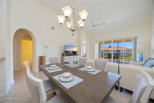 3057 Driftwood Way Unit 4004, Naples, FL 34109 - dining space with arched walkways, high vaulted ceiling, ceiling fan, light tile patterned floors, and baseboards