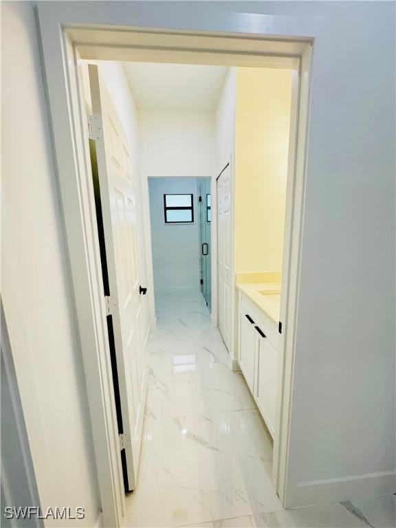 corridor with marble finish floor