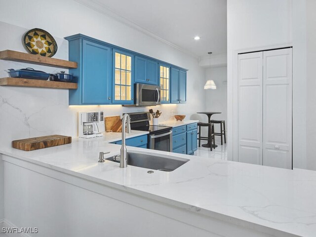 114 Amblewood Ln Unit 9-903, Naples, FL 34105 - kitchen featuring blue cabinetry, appliances with stainless steel finishes, crown molding, open shelves, and light stone counters
