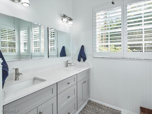114 Amblewood Ln Unit 9-903, Naples, FL 34105 - bathroom featuring double vanity and wainscoting