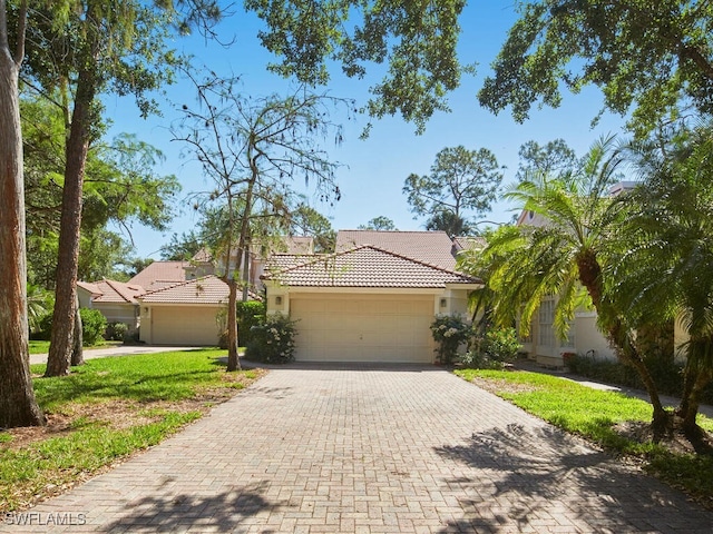 114 Amblewood Ln Unit 9-903, Naples, FL 34105 - view of front facade with a tiled roof, a garage, decorative driveway, and stucco siding