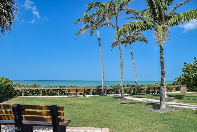view of property's community featuring a water view and a yard