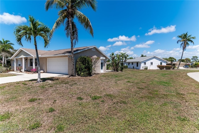 ranch-style home with a front yard, stucco siding, a garage, and concrete driveway