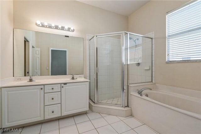 bathroom with a bath, a sink, double vanity, and a stall shower