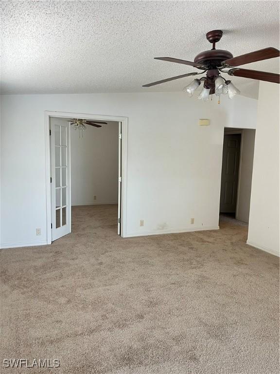 901 Thatcher Blvd, Moore Haven, FL 33471 - unfurnished room featuring light colored carpet, ceiling fan, a textured ceiling, and baseboards