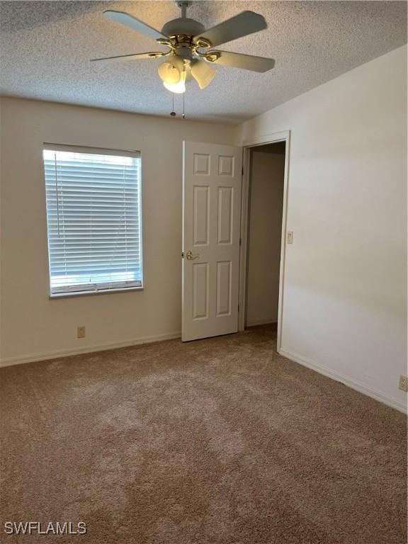 901 Thatcher Blvd, Moore Haven, FL 33471 - empty room with a ceiling fan, carpet floors, a textured ceiling, and baseboards