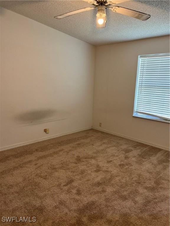 901 Thatcher Blvd, Moore Haven, FL 33471 - carpeted spare room with a textured ceiling, ceiling fan, and baseboards