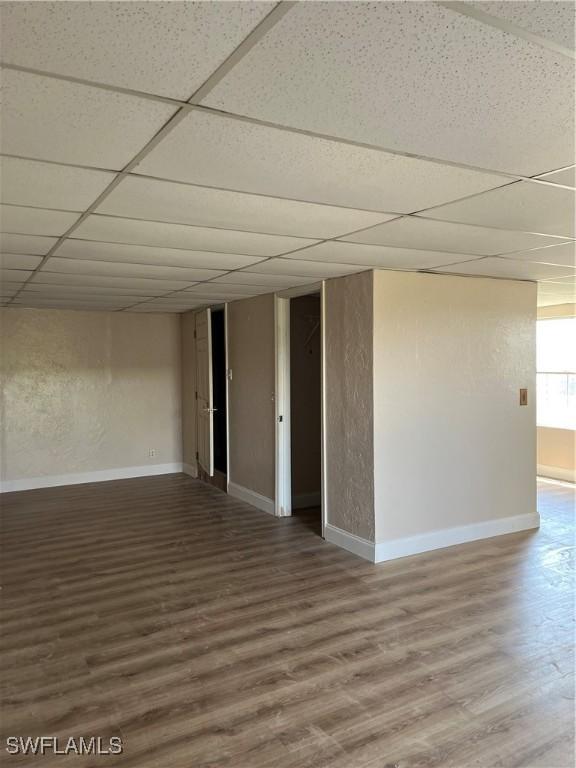 901 Thatcher Blvd, Moore Haven, FL 33471 - unfurnished room with wood finished floors, a drop ceiling, and baseboards