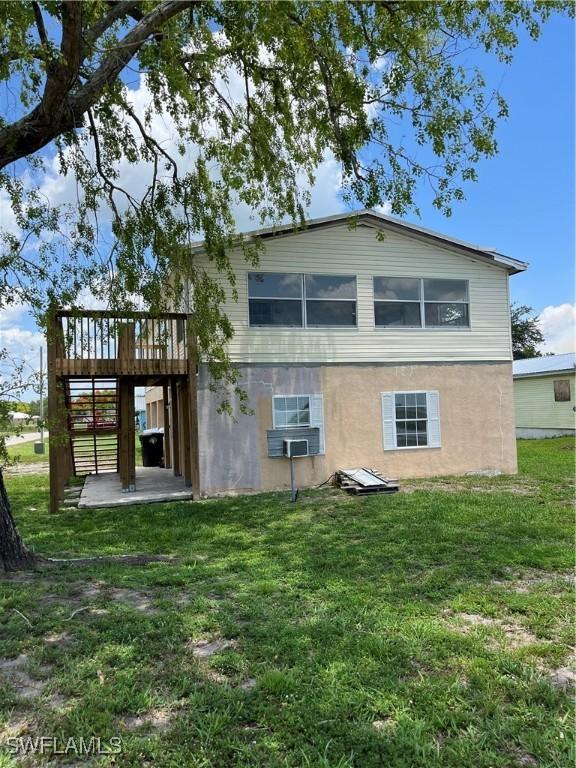 901 Thatcher Blvd, Moore Haven, FL 33471 - back of house with a wooden deck, a yard, stairs, and cooling unit