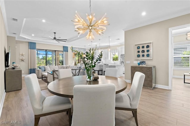 dining room featuring baseboards, light wood finished floors, and a healthy amount of sunlight