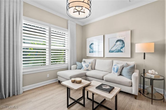 living area featuring baseboards, a chandelier, a healthy amount of sunlight, crown molding, and wood finished floors