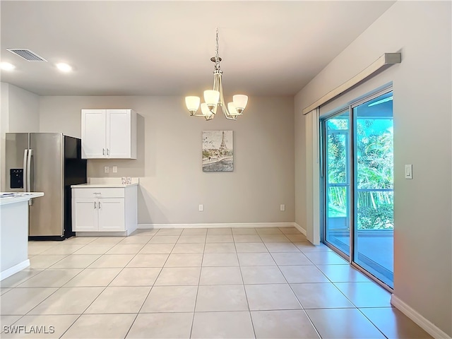 24692 Rio Villa Lakes Cir, Punta Gorda, FL 33950 - kitchen featuring an inviting chandelier, stainless steel fridge, light countertops, white cabinets, and visible vents