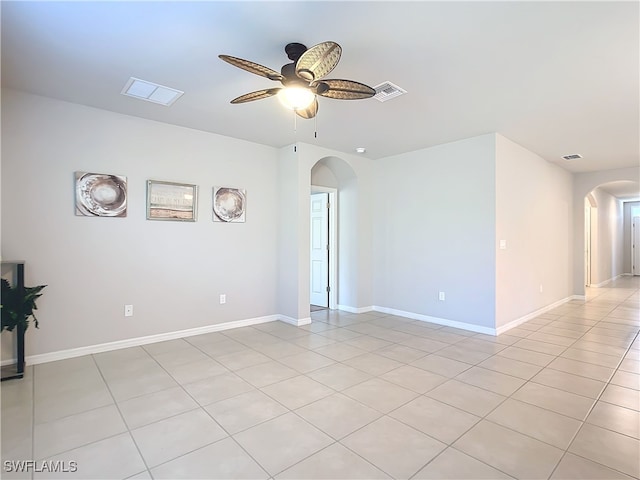 24692 Rio Villa Lakes Cir, Punta Gorda, FL 33950 - empty room with visible vents, baseboards, a ceiling fan, and arched walkways