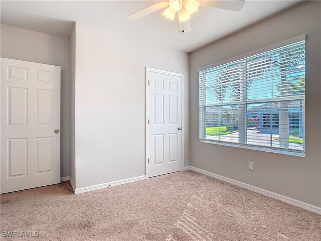 24692 Rio Villa Lakes Cir, Punta Gorda, FL 33950 - unfurnished bedroom featuring ceiling fan, carpet flooring, and baseboards
