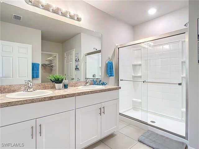 24692 Rio Villa Lakes Cir, Punta Gorda, FL 33950 - full bath with tile patterned floors, visible vents, a sink, and a stall shower