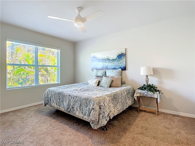 24692 Rio Villa Lakes Cir, Punta Gorda, FL 33950 - bedroom with baseboards, a ceiling fan, and carpet