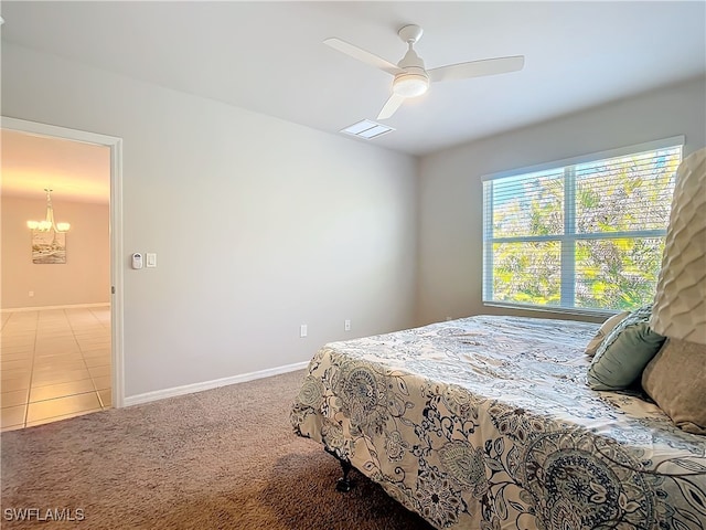 24692 Rio Villa Lakes Cir, Punta Gorda, FL 33950 - carpeted bedroom featuring visible vents, baseboards, and ceiling fan with notable chandelier