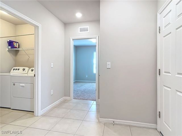 24692 Rio Villa Lakes Cir, Punta Gorda, FL 33950 - laundry room with baseboards, light tile patterned floors, visible vents, laundry area, and washing machine and clothes dryer