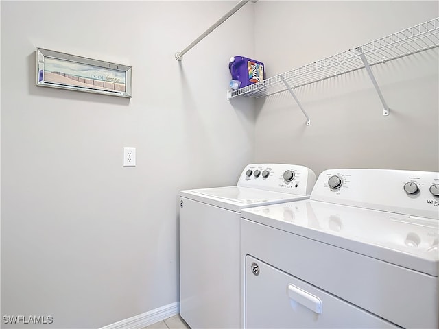 24692 Rio Villa Lakes Cir, Punta Gorda, FL 33950 - washroom with washer and clothes dryer, laundry area, and baseboards