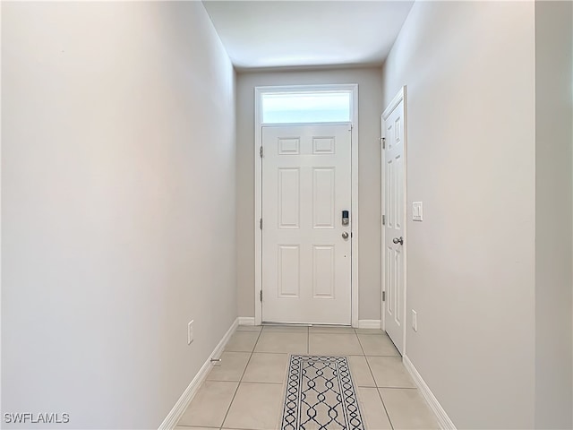 24692 Rio Villa Lakes Cir, Punta Gorda, FL 33950 - doorway with light tile patterned floors and baseboards