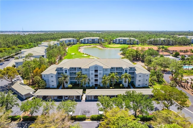 drone / aerial view with a water view and golf course view