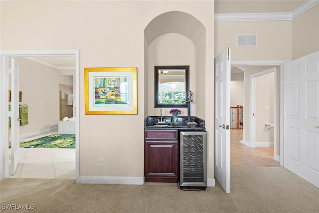 3536 Cherry Blossom Ct Unit 201, Estero, FL 33928 - corridor with beverage cooler, light carpet, crown molding, and light tile patterned flooring