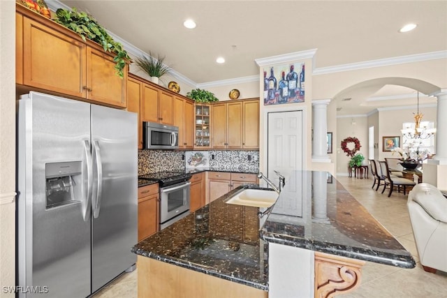 3536 Cherry Blossom Ct Unit 201, Estero, FL 33928 - kitchen with stainless steel appliances, arched walkways, decorative columns, tasteful backsplash, and ornamental molding