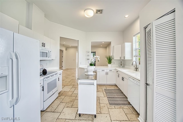 5482 Peppertree Dr, Fort Myers, FL 33908 - kitchen featuring visible vents, white cabinets, a sink, white appliances, and stone tile floors