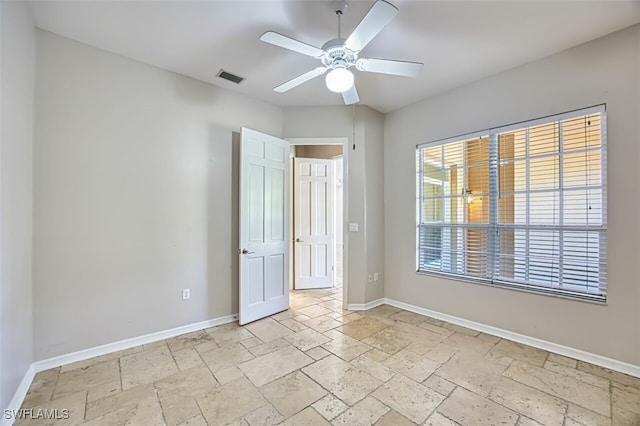 5482 Peppertree Dr, Fort Myers, FL 33908 - unfurnished bedroom featuring visible vents, baseboards, a ceiling fan, and stone tile flooring