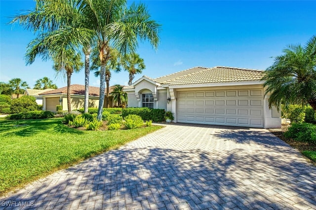 5482 Peppertree Dr, Fort Myers, FL 33908 - ranch-style home featuring stucco siding, driveway, a front yard, a tile roof, and a garage