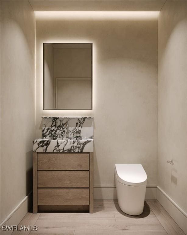 936 5th Ave S Unit 202, Naples, FL 34102 - half bath with toilet, wood finished floors, vanity, and baseboards