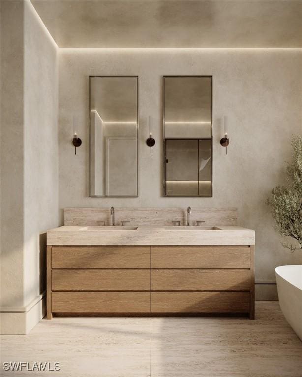 936 5th Ave S Unit 202, Naples, FL 34102 - bathroom with a soaking tub, double vanity, a sink, and wood finished floors