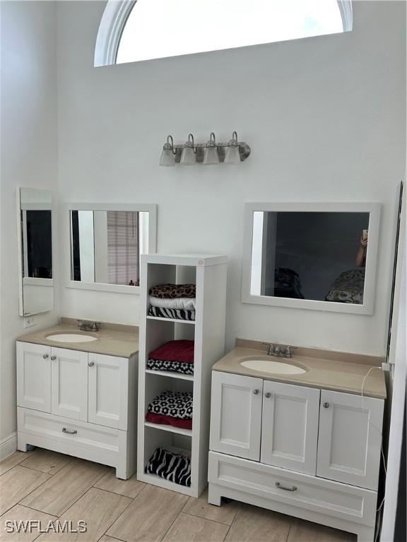 8860 Banyan Cove Cir S Unit 0, Fort Myers, FL 33919 - bathroom with two vanities and plenty of natural light