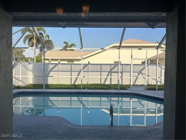 8860 Banyan Cove Cir S Unit 0, Fort Myers, FL 33919 - view of pool featuring glass enclosure and a fenced backyard