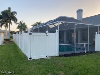 8860 Banyan Cove Cir S Unit 0, Fort Myers, FL 33919 - rear view of house featuring glass enclosure