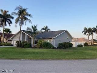 8860 Banyan Cove Cir S Unit 0, Fort Myers, FL 33919 - view of front of property with an attached garage and a front lawn