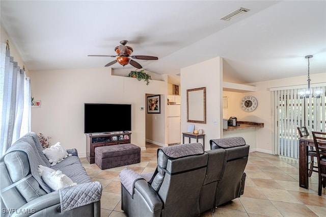 living room featuring vaulted ceiling, visible vents, light tile patterned floors, baseboards, and ceiling fan with notable chandelier