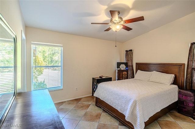 bedroom featuring vaulted ceiling, a ceiling fan, and light tile patterned floors