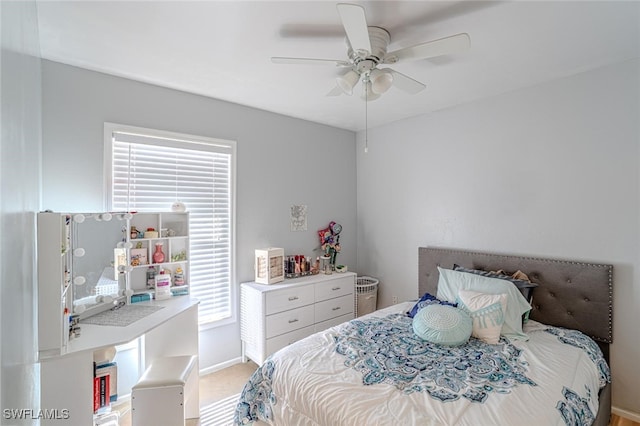 bedroom featuring a ceiling fan and baseboards