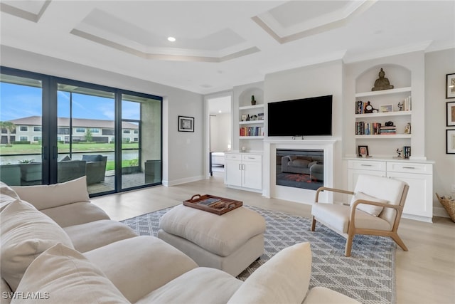 living room featuring light wood finished floors, baseboards, and crown molding