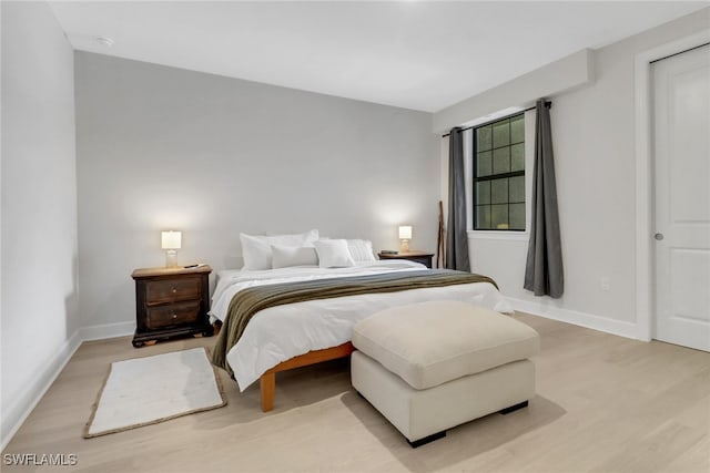 bedroom featuring light wood-type flooring and baseboards