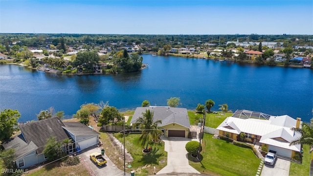 drone / aerial view featuring a residential view and a water view