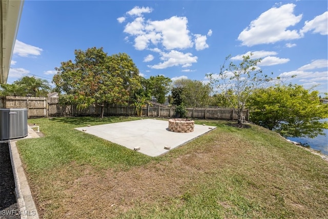 view of yard featuring a fenced backyard, central AC unit, and a patio area