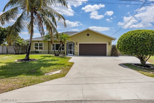 ranch-style house with fence, a front lawn, concrete driveway, stucco siding, and a garage